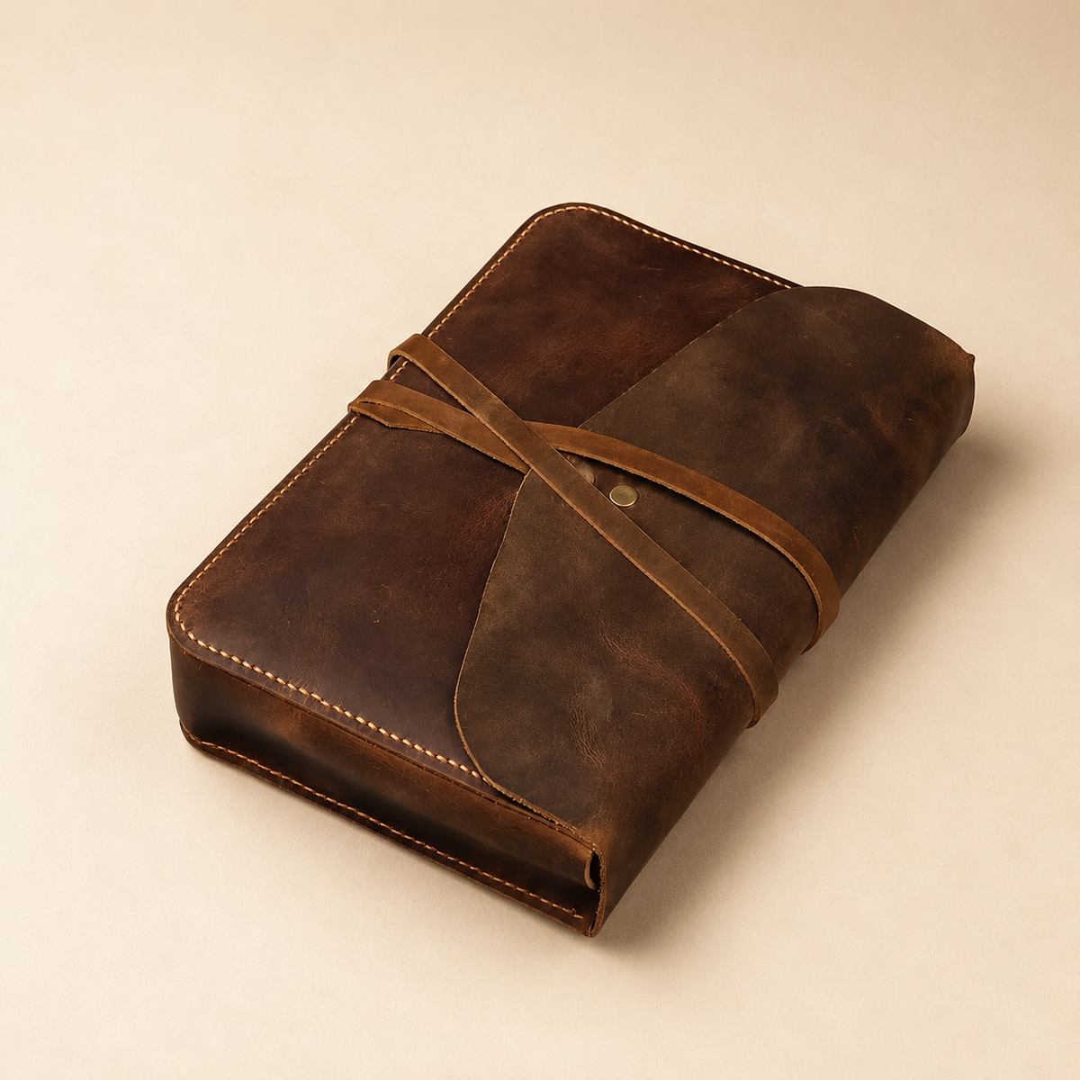 Close-up of custom name engraving on a vintage wrap-tie leather Bible cover