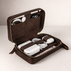 Brown travel case with electronic devices on a light background