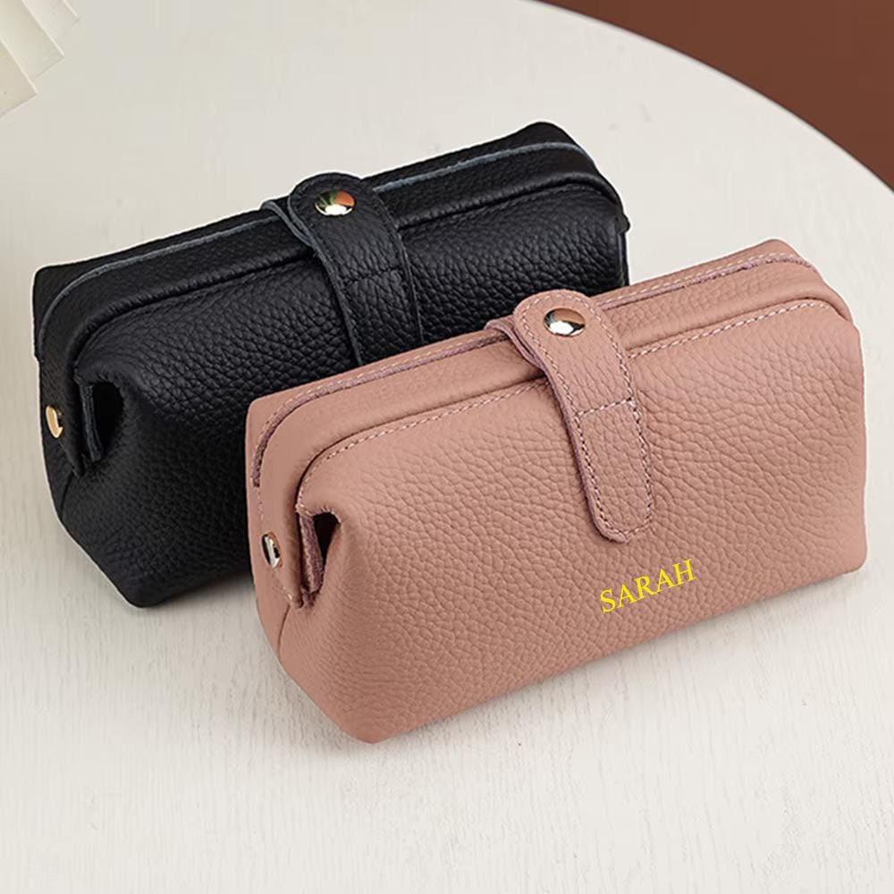 Close-up of gold-tone zipper on a leather makeup bag