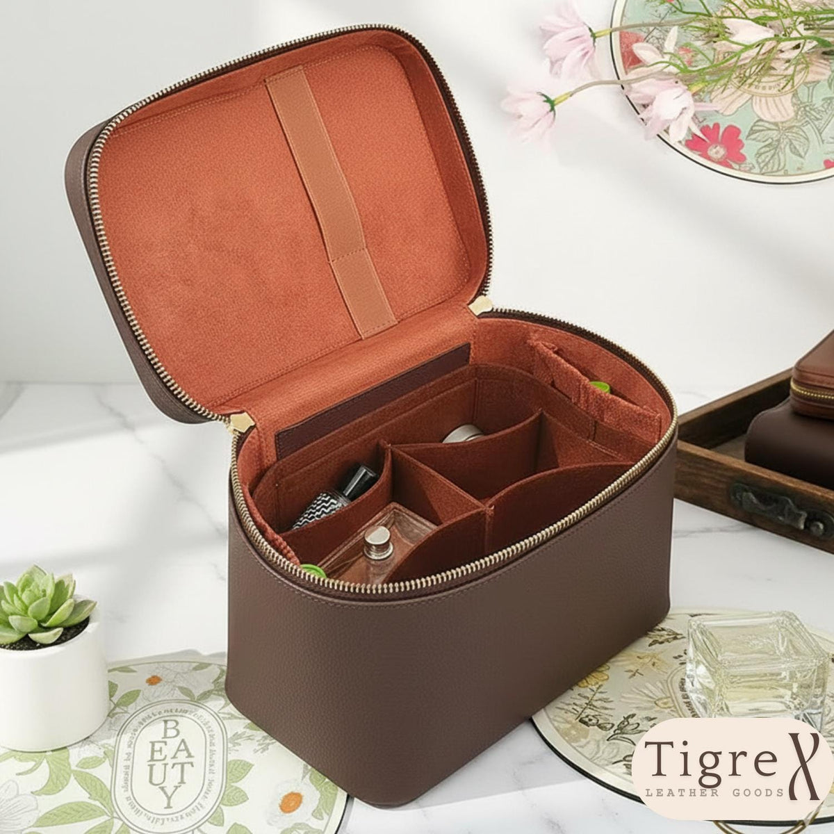 Leather cosmetic bag shown open with multi-compartment interior