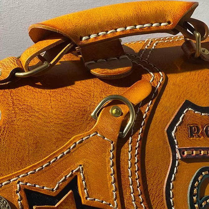 Close-up of brass hardware on a leather biker backpack