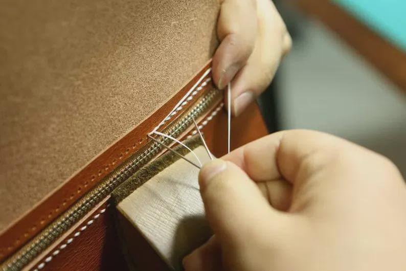 Close-up of full-grain leather stitching on a passport holder