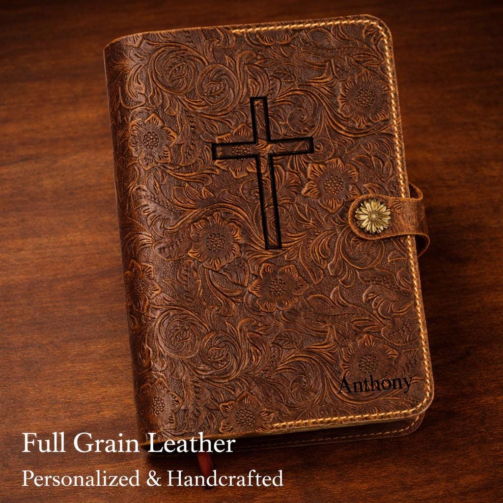Purple leather Bible cover styled with a matching pen, handcrafted full-grain detail