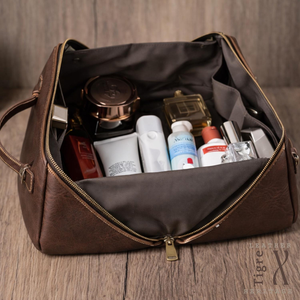Leather toiletry bag shown open with compartments