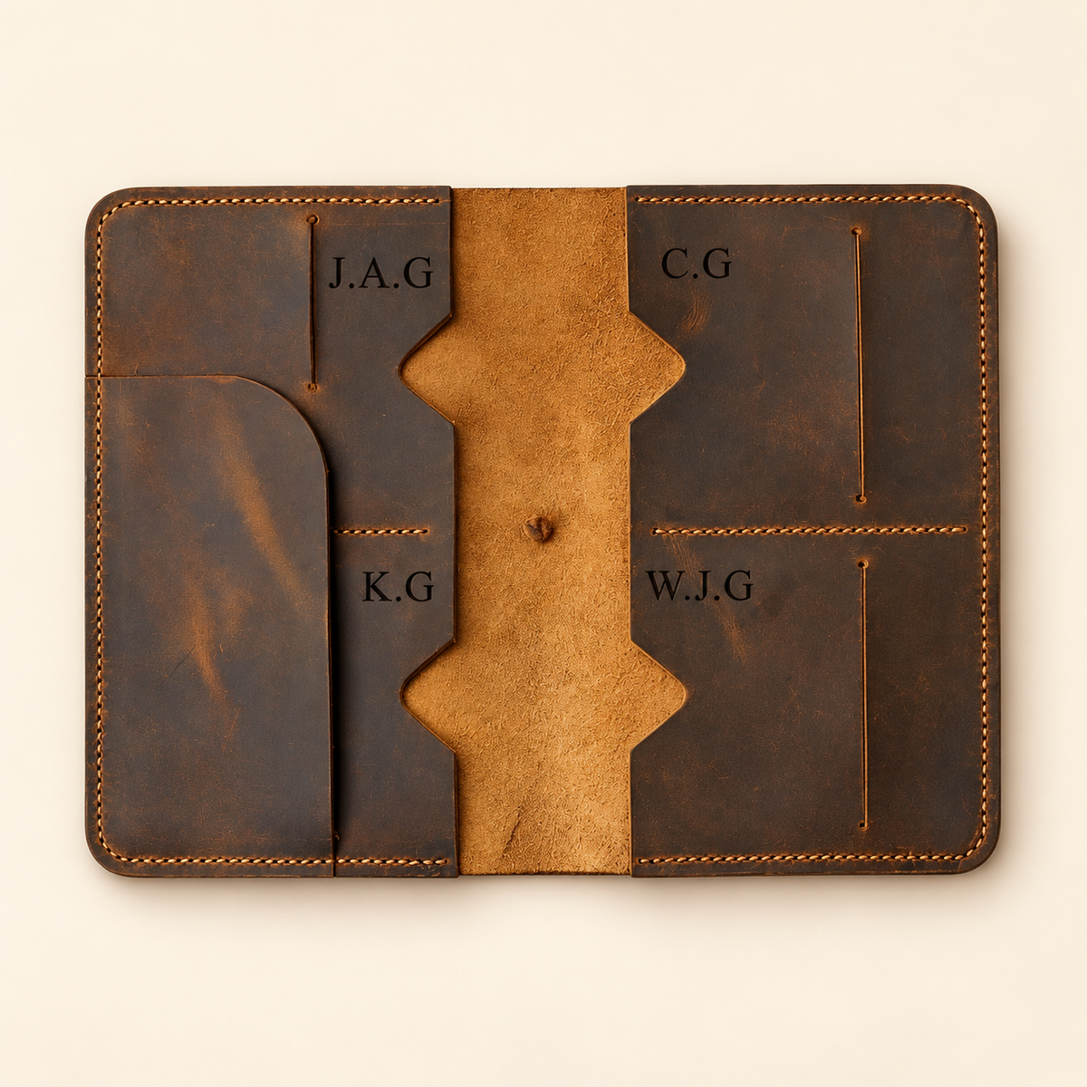 Open TigreX Studio six-passport full-grain leather organizer with individual initials engraved inside the passport compartments