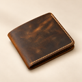 Hand-stitched distressed full-grain brown leather bifold wallet, closed front view