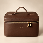 Personalized brown genuine leather cosmetic makeup case with gold zipper and embossed initials, luxury studio hero photo