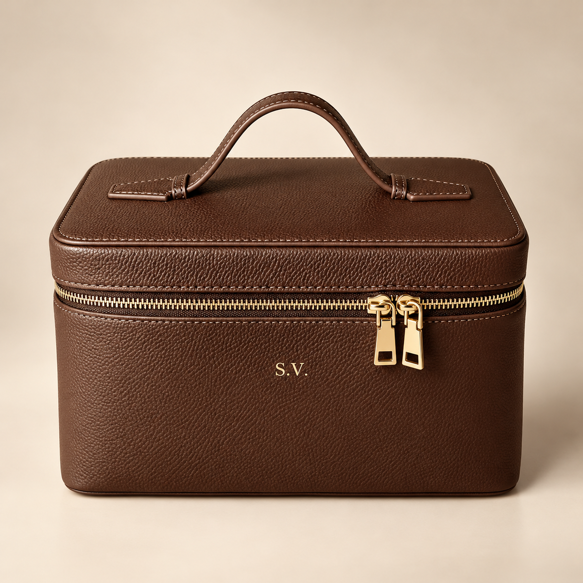Personalized brown genuine leather cosmetic makeup case with gold zipper and embossed initials, luxury studio hero photo