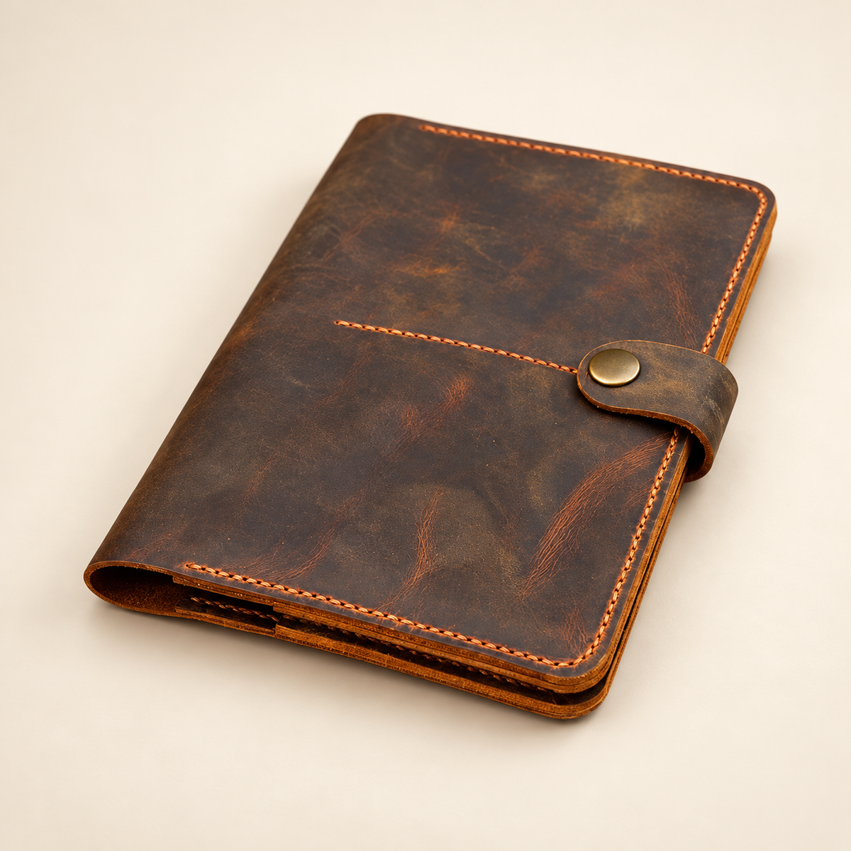 Angled view of TigreX Studio personalized full-grain leather travel wallet with hand stitching and snap strap