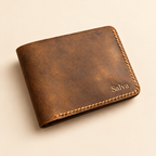 Distressed brown leather bifold wallet with pressed name Salva near lower right corner