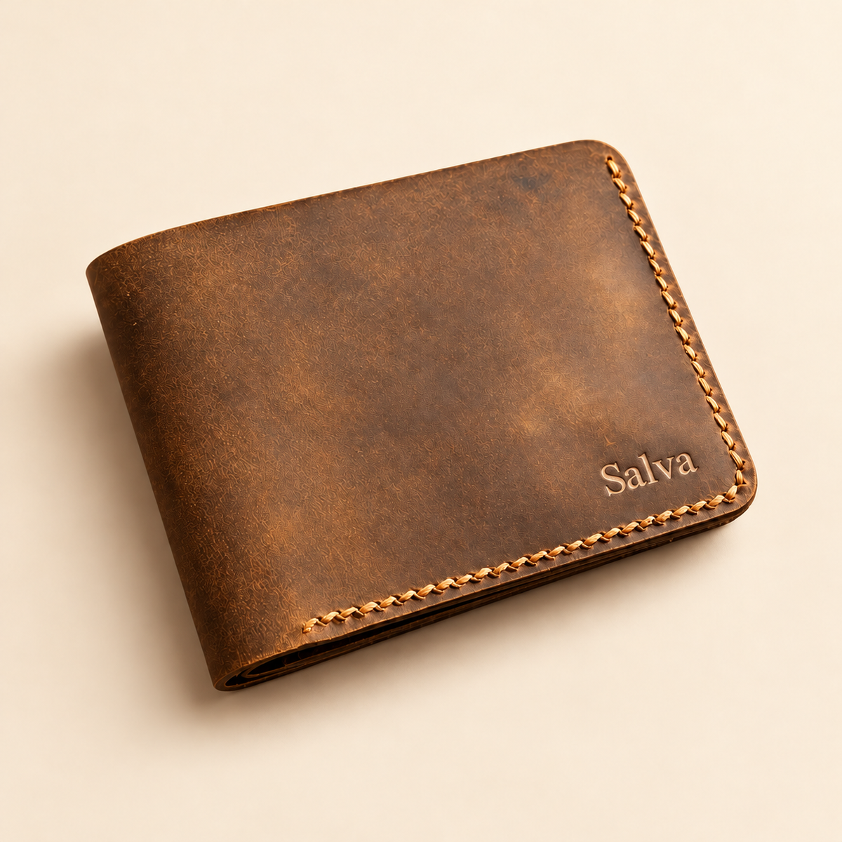 Distressed brown leather bifold wallet with pressed name Salva near lower right corner